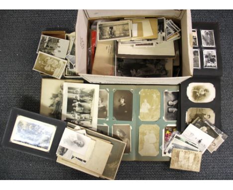 A 1920's album of postcards and photographs, together with a large quantity of vintage photographs.