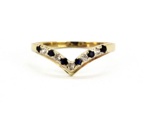 A yellow metal (tested 9ct gold) spinel and white stone set wishbone ring, (K.5).