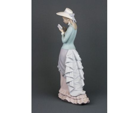 A Lladro bisque porcelain figure of a lady reading a book, H. 36cm.