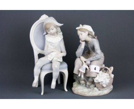 Two Lladro bisque porcelain figures of child dressed as a harlequin and a girl with a doll, H. 25cm.