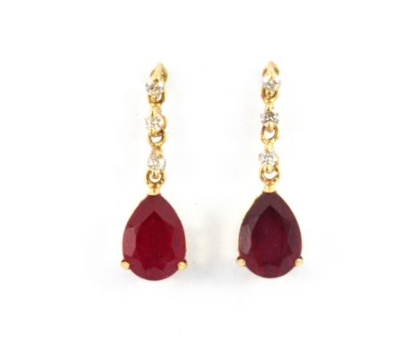 A pair of 18ct yellow gold pear cut ruby and diamond set drop earrings, L. 1.6cm.