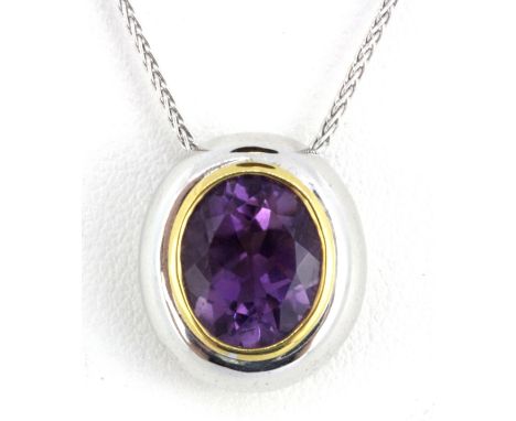 A matching 18ct white gold (stamped 750) pendant and chain set with oval cut amethyst, L. 1.5cm.