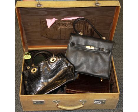 A vintage pig skin suitcase and vintage handbag contents, case size 36 x 55 x 18cm.