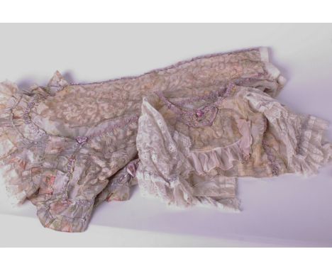 An early 20th Century silk, lace and appliqué skirt with matching bodice; a cream sleeveless lace blouse, a lace and net baby