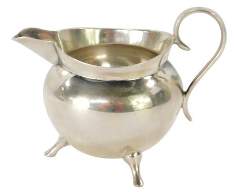 A Victorian Mappin &amp; Webb silver milk jug, of plain cauldron design on tripod base, Sheffield 1896, 2 ¼oz. 