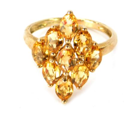 A 9ct gold dress ring, the diamond shaped centre design formed of nine oval cut citrines, in a raised basket claw setting, ri