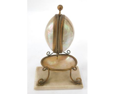 A 19thC French mother of pearl and brass Palais Royale watch stand, the two capped shell top with bowl on a rectangular foot,