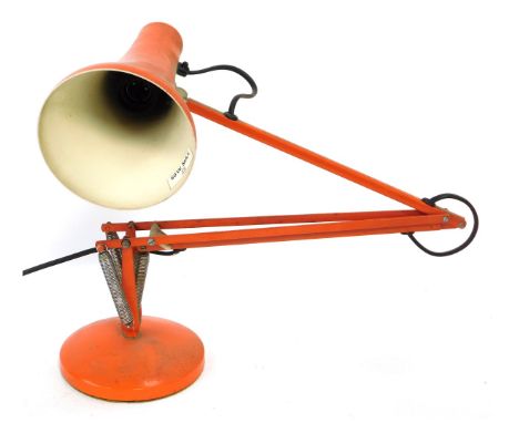 An orange Anglepoise desk lamp, 82cm high when fully extended.