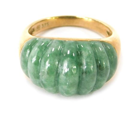 A 9ct gold jade set dress ring, the ribbed design jade in rub over setting, ring size P, 6.6g all in.