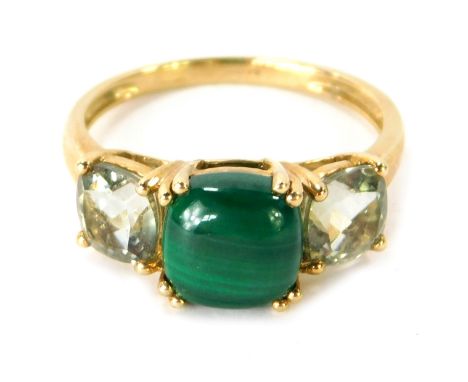 A 9ct gold dress ring, the central oval malachite stone in four double claw setting, with outer pale green topaz set stones, 