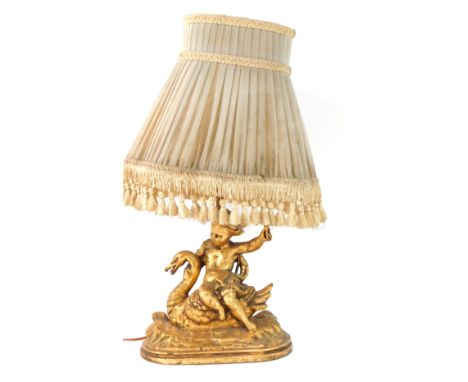 A gilt table lamp, of Putti Riding Swan, 41cm high. (AF)WARNING! This lot contains untested or unsafe electrical items. It is