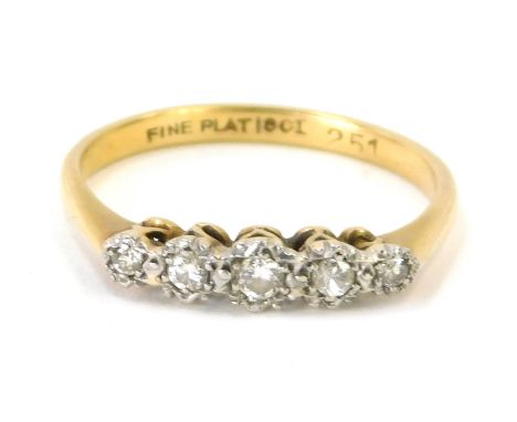 An 18ct gold and plat diamond five stone dress ring, set with five illusion set diamonds in platinum, on a yellow metal band,