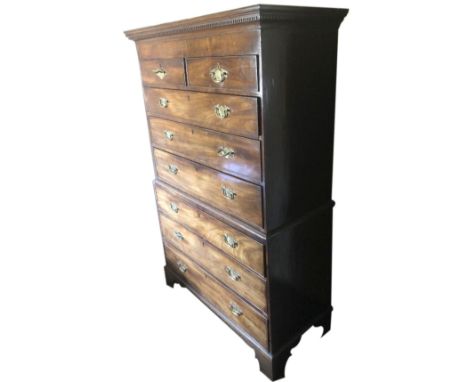 A George III tallboy, or chest on chest, with dentil moulded cornice an arrangement of two over three graduated drawers to th