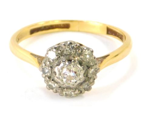 An 18ct gold diamond dress ring, with raised cluster with diamond set in illusion setting, stamped 18ct plat., size P ½, 3.3g