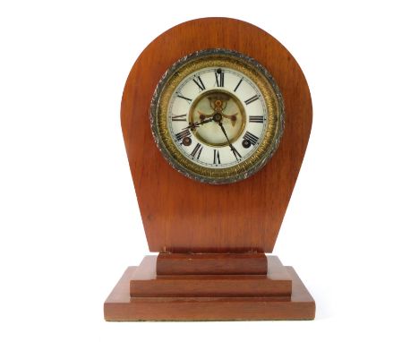 An Ansonia Clock Company mantel clock movement, in the Art Deco style with a shaped top, on three stepped base, with white en