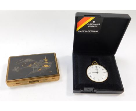 A musical compact, the top with Eastern engraved design, and a Sekonda German pocket watch. (2)