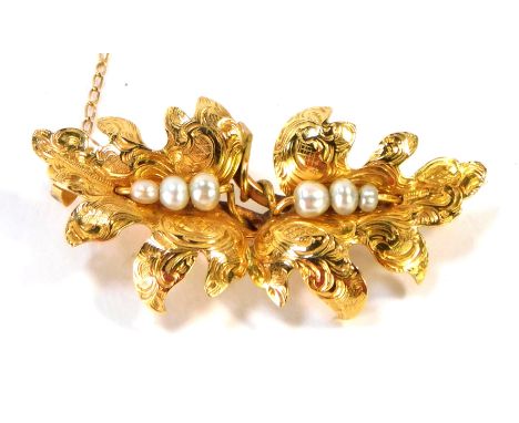 A late Edwardian leaf moulded brooch, formed as two interlinked vines, with cultured pearl decoration on single pin back, wit