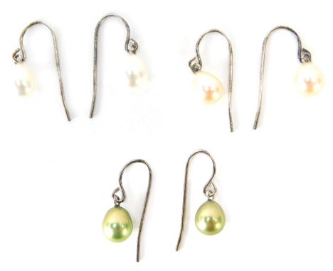 Three pairs of cultured pearl and silver drop earrings, comprising cream, peach and green lustre, 4.9g all in.