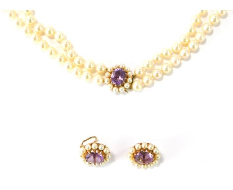 A cultured pearl jewellery suite, comprising two strand graduated necklace and earrings, the necklace, 82cm long overall, the