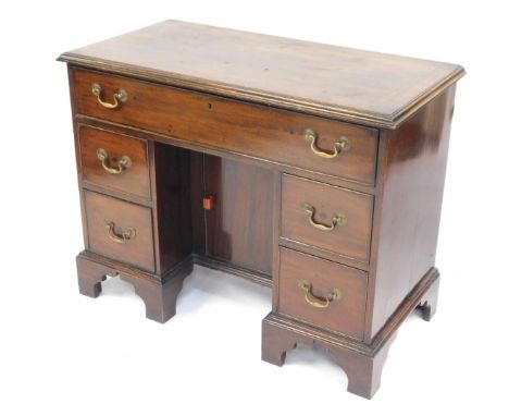 An early 20thC mahogany kneehole desk, in mid 18thC style, the cross banded top with a moulded edge above one long and four s