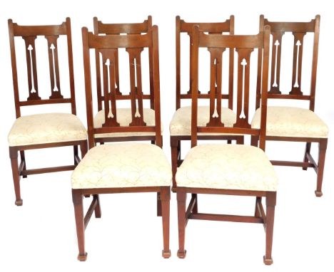 A set of six oak Arts &amp; Crafts dining chairs, each with a diamond back in cream and gold leaf upholstered seats.