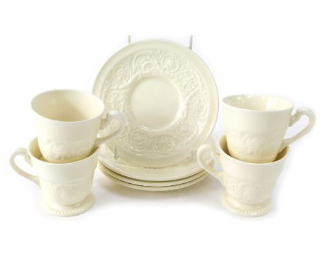 A Wedgwood set of four coffee cans and saucers in the Patrician pattern, each on a cream ground with floral decoration.