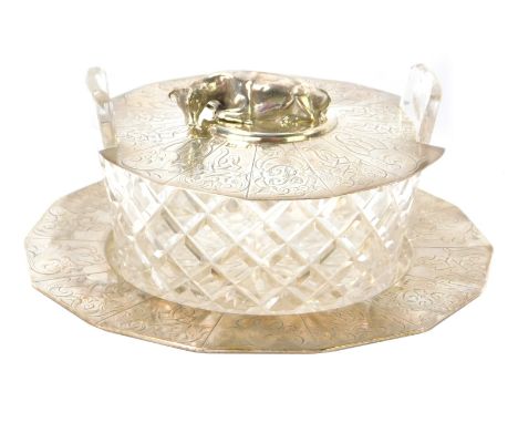 A Victorian silver butter dish, with hexagonal base with crested panels, bearing the initial B, London, with cut glass bowl, 