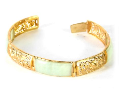A 9ct gold and jade bracelet, of six sectional design, with three rectangular panels of light jade and four pierced Eastern s