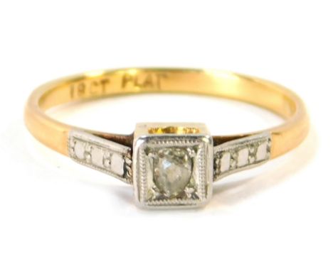 An 18ct gold and plat diamond solitaire ring, the square set panel with old cut tiny diamond, in platinum setting on a yellow