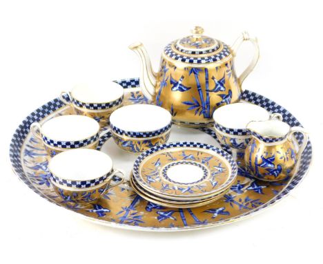 A 19thC Coalport Tete a Tete service, with royal blue bamboo and swallow design on a gilt border, comprising large circular s