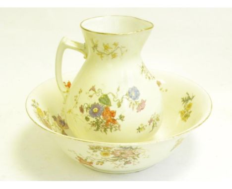 A FRENCH PORCELAIN CREAM GROUND CHAMBER JUG AND BASIN, FLORAL DECORATED, CIRCA 1900