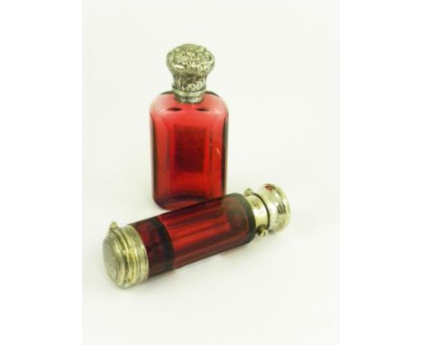 A VICTORIAN SILVER  MOUNTED RUBY GLASS COMBINATION SCENT BOTTLE-VINAIGRETTE AND A VICTORIAN SILVER  MOUNTED RUBY GLASS SCENT 