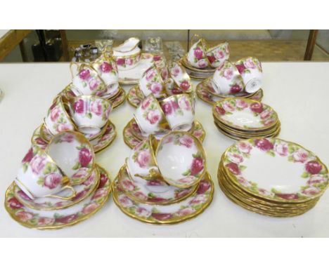 AN EXTENSIVE ROYAL ALBERT  TEA SERVICE, DECORATED WITH BORDERS OF ROSES AND GILT 