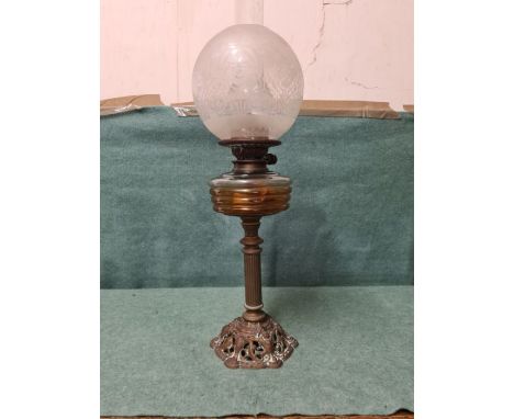 Hinks Duplex burner oil lamp with amber vessel and brass base modeled with cherubs heads.