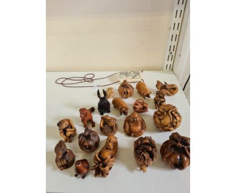 Collection of 20 hardwood 20th century netsuke, some signed together with an Oxbone Inro with erotic and dragon decoration.