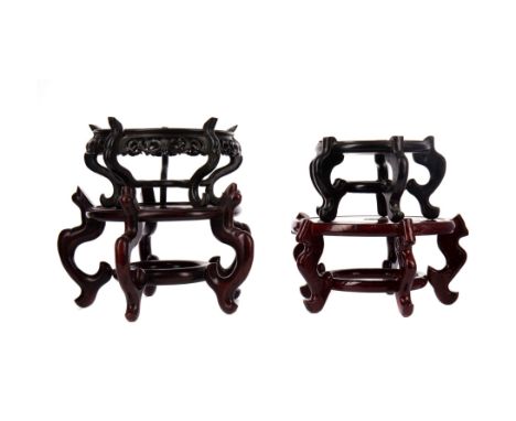 COLLECTION OF FOUR CHINESE HARDWOOD STANDS, including one example with a scroll carved frieze, the largest 16.5cm high, 26cm 