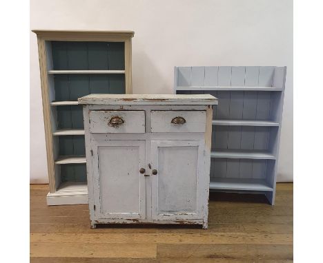 A pained pine dresser base, having two short drawers and two cupboard doors, 92 cm wide, a painted bookcase, 76 cm wide, and 