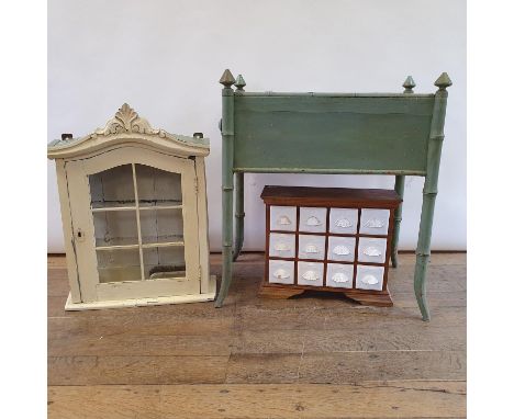 A painted bottle stand, raised on faux bamboo legs, 64 cm wide, a painted wall cabinet, 51 cm wide, and a spice rack (3) 