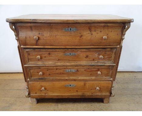 A 19th Century continental pine serpentine top commode, having three drawers, 95 cm wide 