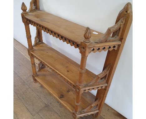 A late 19th/early 20th century pine wall hanging shelf, in the Gothic manner, 80 cm wide 