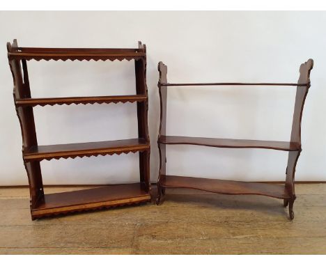 A 19th century mahogany wall shelf, 61 cm wide, another, 54 cm wide, and a carved finial, 63 cm wide (3) 