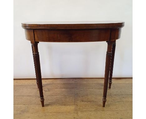 A 19th century mahogany demi lune card table, on turned reeded tapering legs, 92 cm wideSlight wormed stretchers 