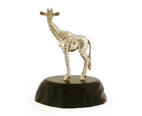 A contemporary silver sculpture of a giraffe, by Patrick Mavros, Zimbabwe,the naturalistically carved ebony base, inset with 