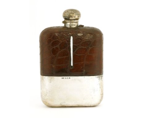 A large silver and crocodile skin bound flask,by Daniel &amp; Arter, Birmingham, 1910, with an hinged cover over a rectangula