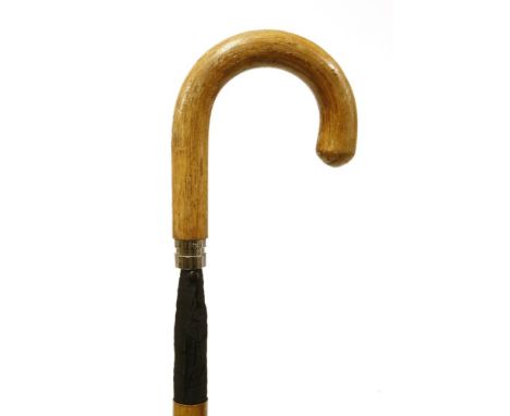 A stout traditional walking stick,c.1900, containing a rolled umbrella,89cm long