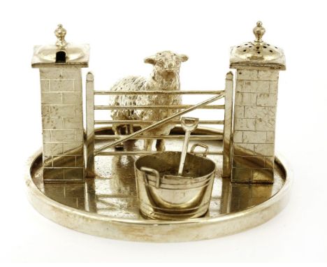A electroplated novelty condiment set,in the form of a ewe before a five-bar gate, the gateposts as condiments, together with
