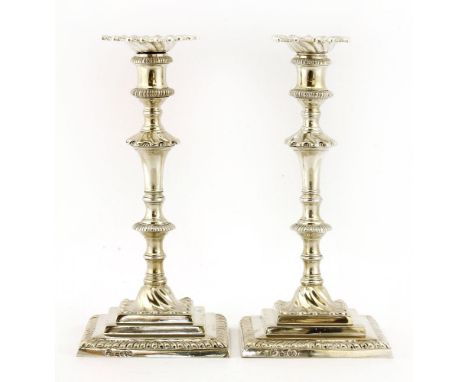 A pair of silver candlesticks,by Robert Garrard, London, 1877,of Georgian design, each with detachable sconces and square bas