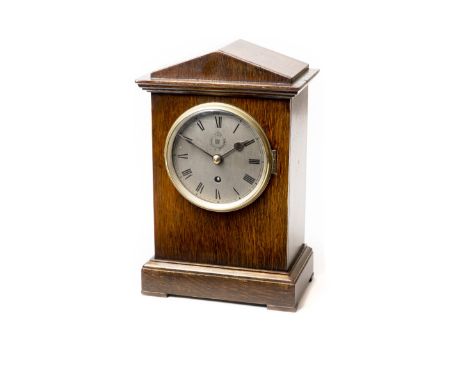 * Royal Air Force. A WWII period RAF Officer's Mess mantel clock, the 13.5cm diameter circular silvered dial with black roman