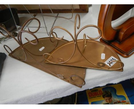 A pair of metal shelf brackets.