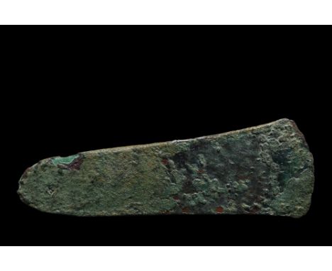 Ca. 1st millennium BC. A flat axe, with a broad, curved cutting edge tapering gently to a rounded butt.Size: L:65mm / W:185mm
